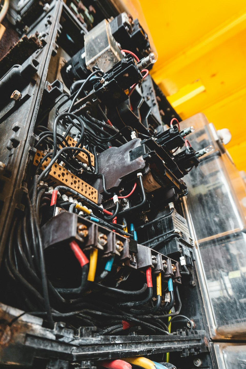 Complex electrical control panel with colorful wires and components.